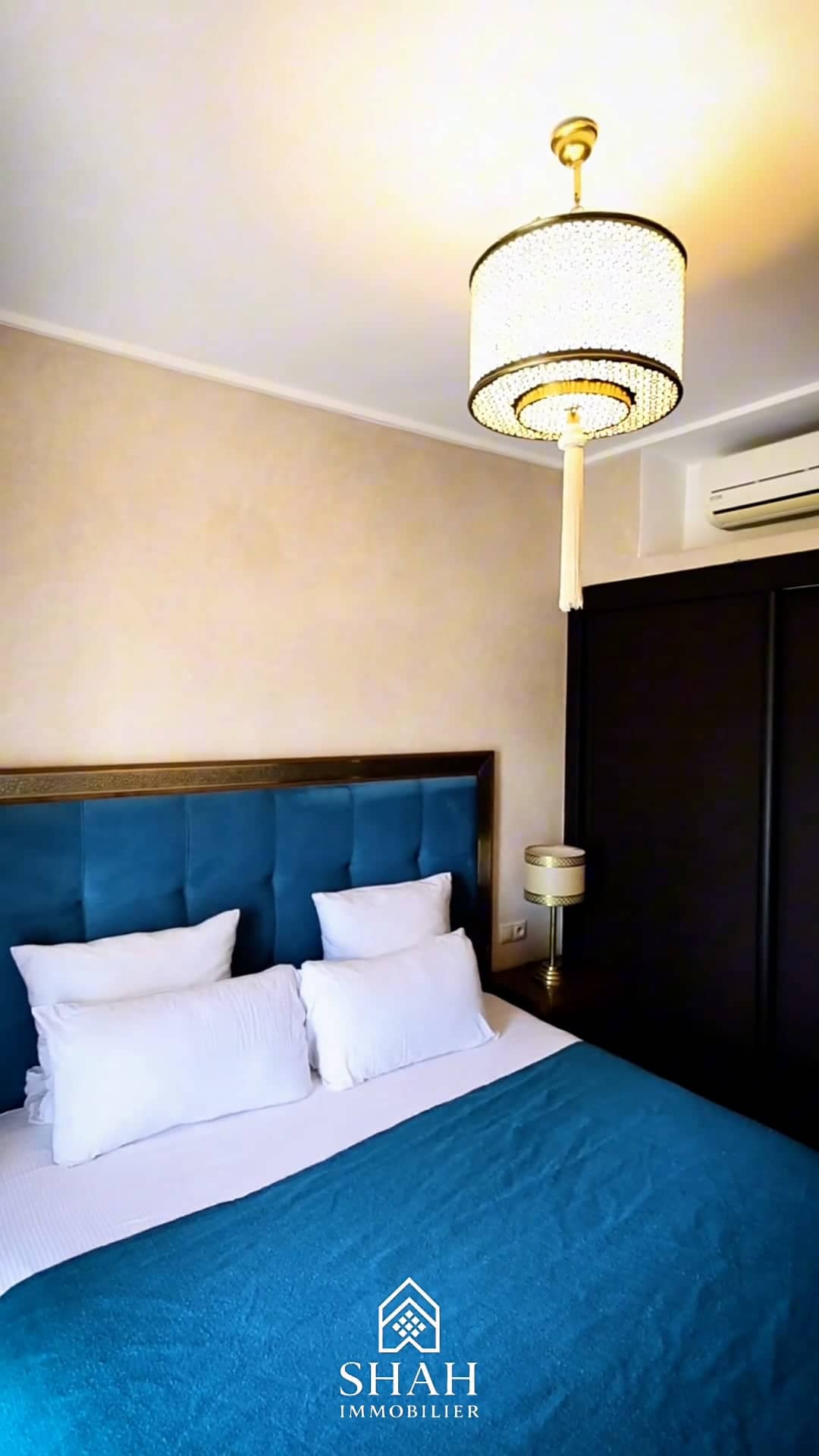 Chambre avec tête de lit capitonnée rouge framboise et porte-fenêtre voilée